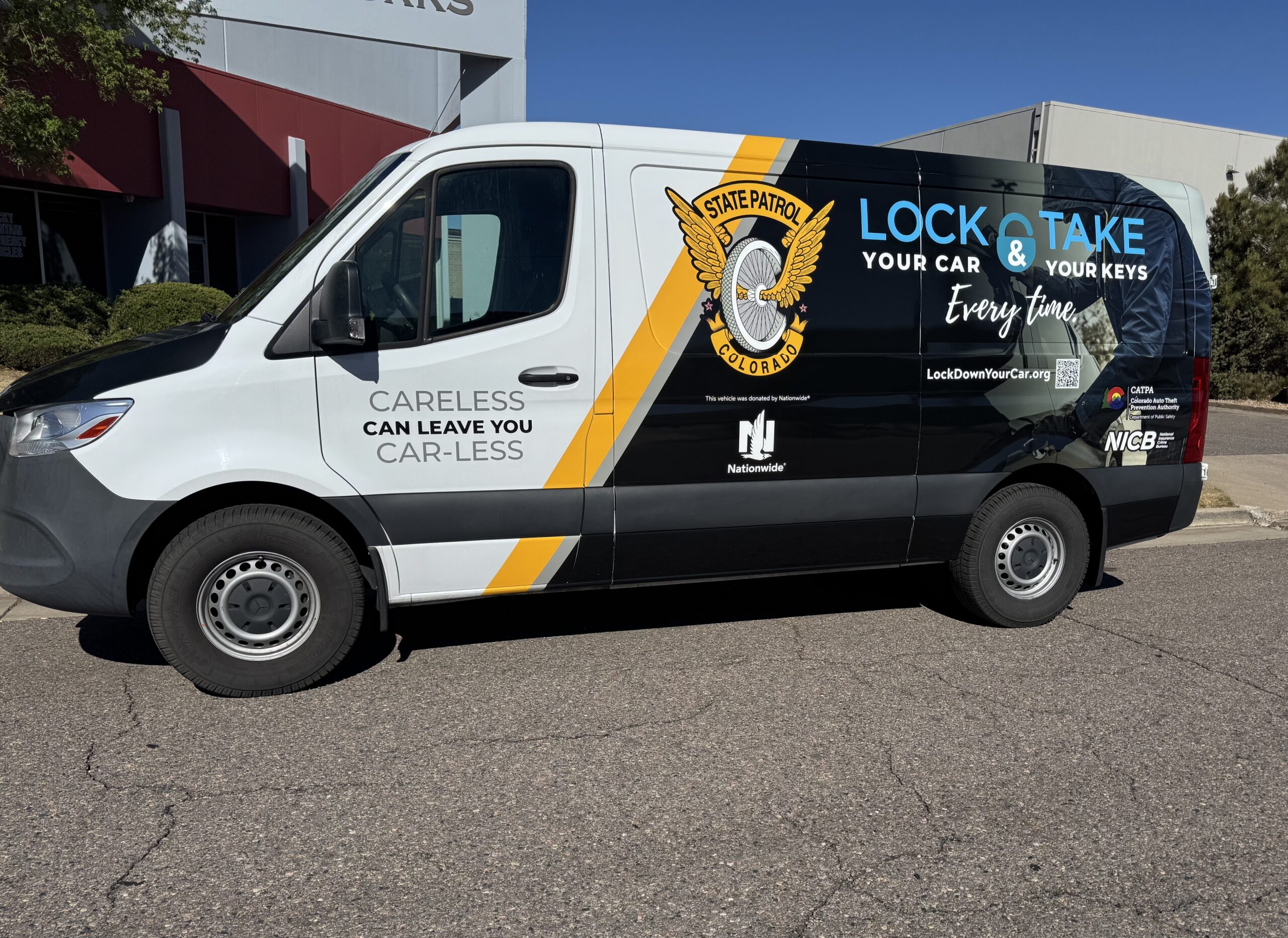 A van with graphic wrap asking people to lock their car and take their keys