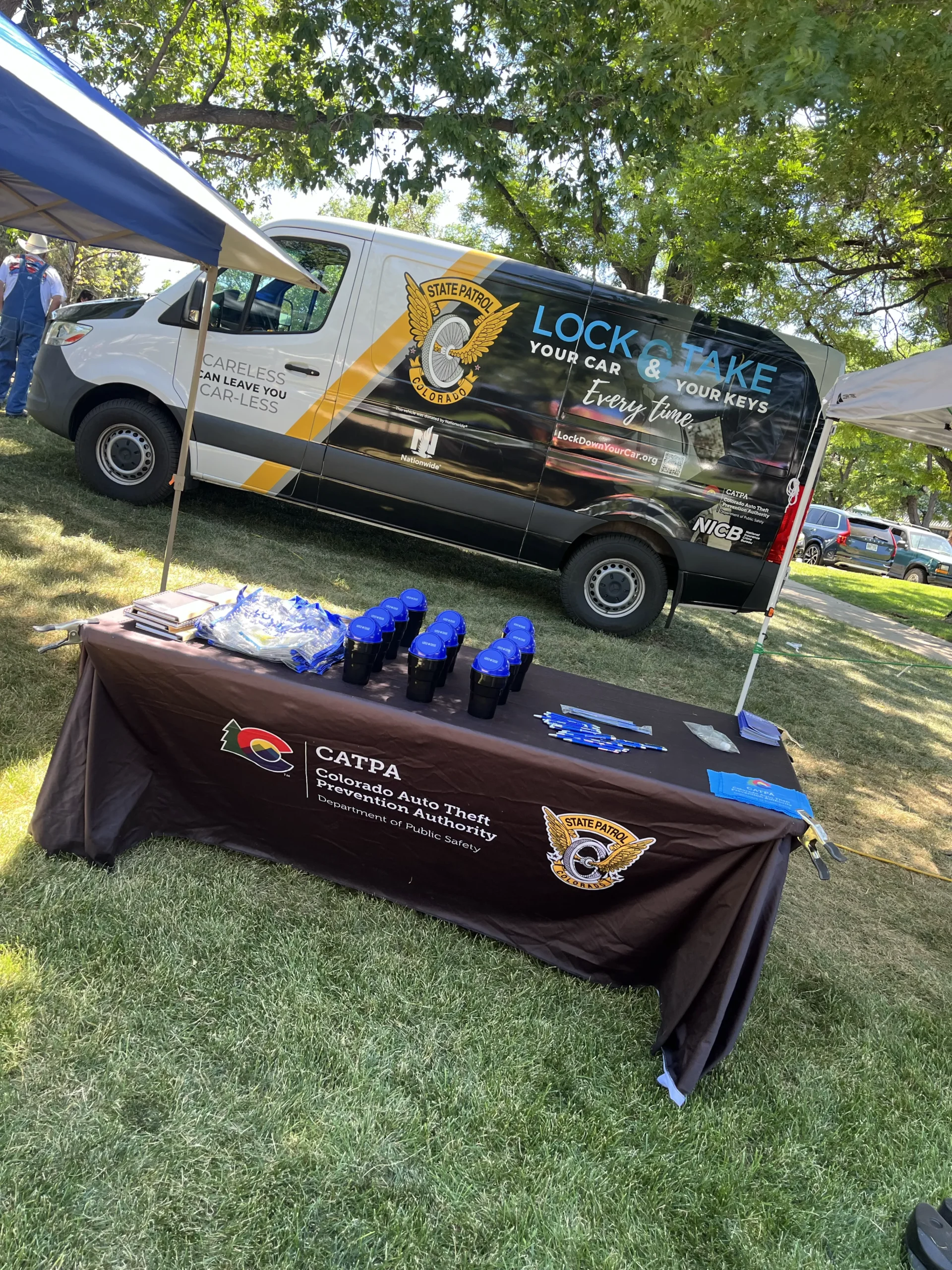 A van in front of a table promoting auto theft prevention